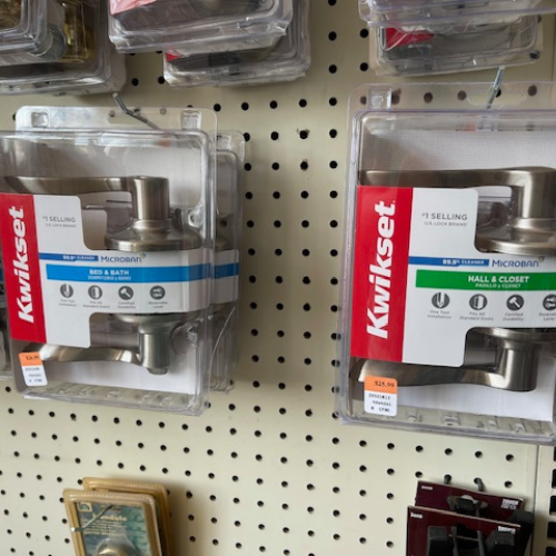 Display of Kwikset products, including Bed & Bath and Hall & Closet door handles.