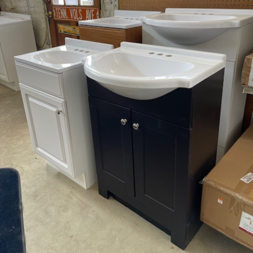 Display of vanities in a range of colors, including white, wood, and black, with options featuring one or two cabinet doors.